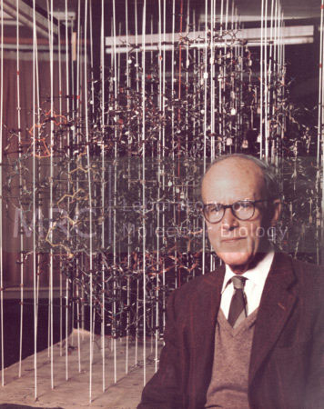 Max Perutz seated in front of his wire model of haemoglobin.