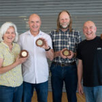 Pat Edwards, Paul Hart, David Cattermole and Steve Scotcher with commemorative plaques made from benches from the old LMB