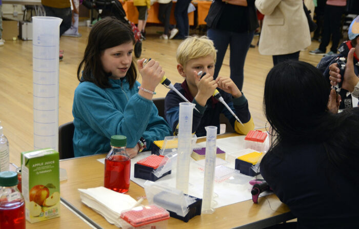 Boy and girl taking part in the pipetting activity