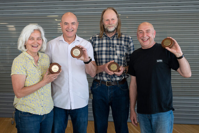 Pat Edwards, Paul Hart, David Cattermole and Steve Scotcher with commemorative plaques made from benches from the old LMB