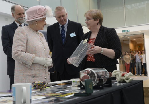 Annette Faux showing a DNA model the HRH Queen Elizabeth II at the Official Opening of the LMB in 2013