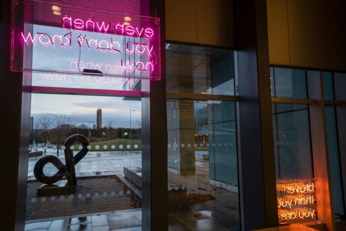 Image of the signs from inside the LMB reception looking out through the glass.