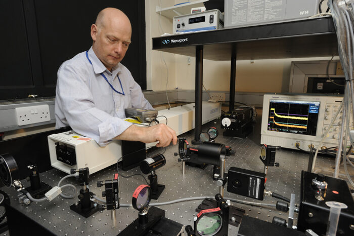 Chris Johnson working with biophysics instruments at the LMB