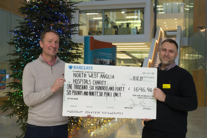 LMB Director Jan Löwe presents a large check to Phillip Fearn, of the North West Hospitals Charity.  
