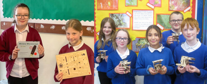 School children hold their microscope prizes.