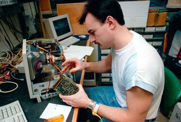 Paul Hart fixing a computer