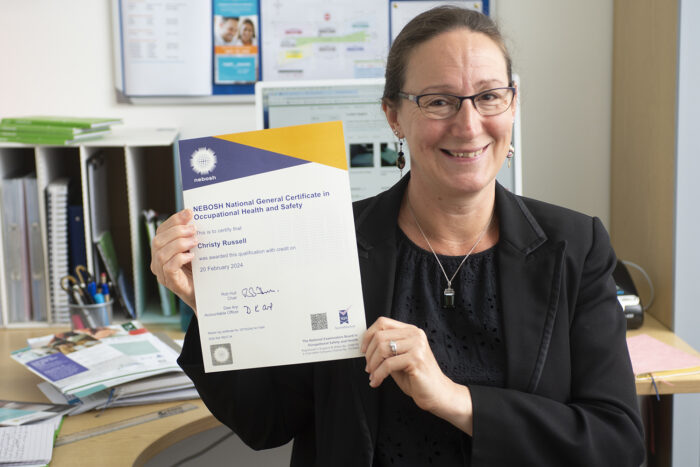 Christy Russell holding a certificate