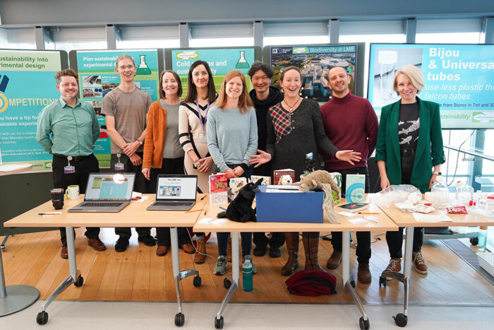 Members of the LMB Green Committee at the recent Sustainability Event, standing in front of posters explaining sustainability initiatives.