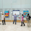 People reading posters showcasing LMB Careers