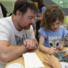 Father and daughter taking part in Exploring the Human Brain with Organoids